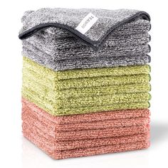 six towels stacked on top of each other in different colors and patterns, one folded up to the side