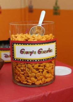 a jar filled with peanuts sitting on top of a table