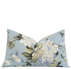 a blue pillow with flowers and birds on it