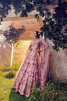 Featuring a salmon pink organza lehenga embellished fully by hand with intricate foliage motifs featuring thread work, sequence, beads and colourful Japanese bugle beads. Paired with a matching blouse and scallop dupattaFrom Aneesh Agarwaal's Ellora collection.DELIVERY TIMEPlease allow 8-12 weeks for your outfit to arrive.FABRIC DETAILSOrganzaProfessional cleaning only. Pink Organza Lehenga, Organza Lehenga, Change Image, Bugle Beads, 12 Weeks, Salmon Pink, Thread Work, Body Measurements, Skirt Length