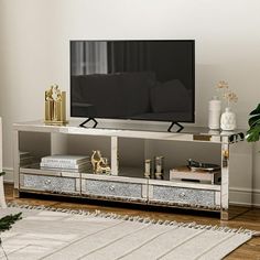 a living room scene with focus on the entertainment center and large screen tv in the background