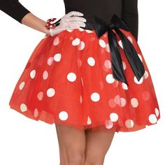 a woman wearing a red and white polka dot skirt with black bow at the waist