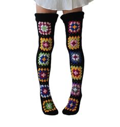 a woman wearing knee high socks with crocheted flowers on them and black over the knee socks