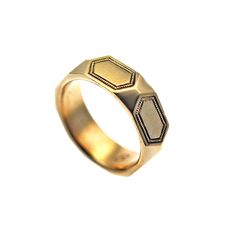 a gold ring with two hexagonals on it