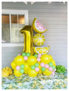 the number one is made out of lemons and limes on top of balloons