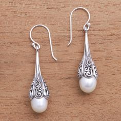 Evoking the elegance of the sea these dangle earrings are designed by Nyoman Rena in Bali. Two glowing white cultured pearls are caressed by intricate swirl patterns crafted from sterling silver and given a combination of finishes. Silver Drop Earrings Wedding, Diy Earrings Dangle, Jewellery Indian, Silver Jewellery Indian, Pearl Dangle Earrings, Boot Jewelry, Earrings Inspiration, Pearl Earrings Dangle, Freshwater Cultured Pearls