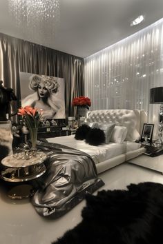 a living room with black and white furniture, chandelier and pictures on the wall