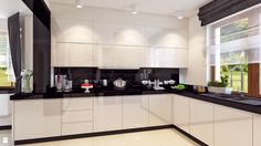 a kitchen with white cabinets and black counter tops, along with potted plants on the window sill