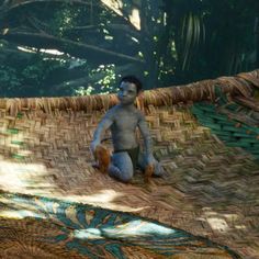 a man sitting on top of a hammock next to a stuffed animal bear