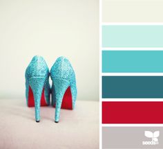 a pair of blue high heeled shoes sitting on top of a white table next to color swatches