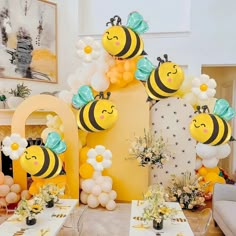 a room filled with lots of balloons and bums on the wall next to tables