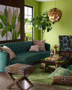 a living room with green walls and leopard print furniture