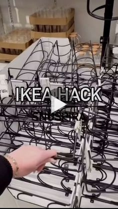 a person pointing at an array of racks with wires attached to them and the words ikea hack on it