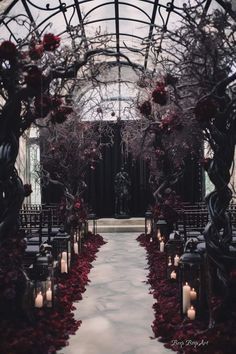 an outdoor ceremony setup with candles and flowers on the aisle, surrounded by glass walls