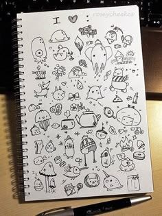 an open notebook with doodles drawn on it