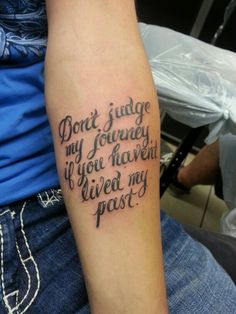 a person with a tattoo saying don't judge my journey if you haven't lived my past