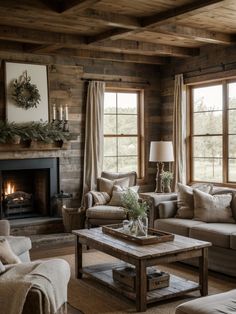 a living room with two couches and a coffee table in front of a fire place