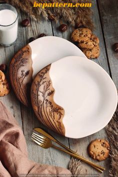 two white plates with cookies on them next to a glass of milk