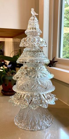 a glass christmas tree sitting on top of a counter