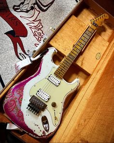 an electric guitar sitting in a wooden case