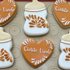 decorated cookies in the shape of heart and jar with name written on them are displayed