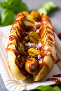 a hot dog on a paper plate covered in ketchup