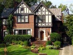 a large brick house with black and white trim