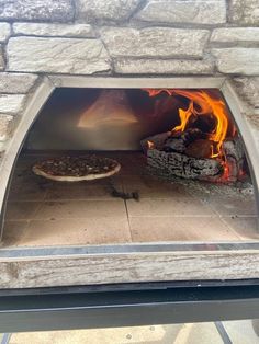 a pizza is cooking in an outdoor oven