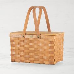 a wooden basket sitting on top of a white table