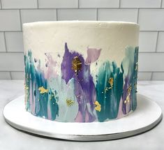 a white cake with purple and blue frosting