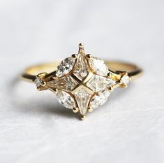 a three stone diamond ring sitting on top of a table