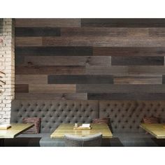 an empty restaurant with wooden tables and benches in front of a wall made of wood planks