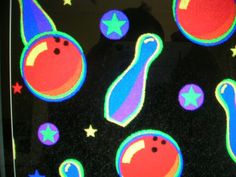 an image of colorful stickers on the glass window with stars and planets around them