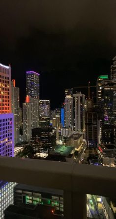 the city skyline is lit up at night