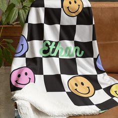 a black and white checkered blanket with smiley faces on it that says stun