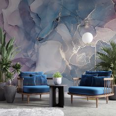 two chairs and a table in front of a wall mural