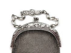 Beautiful silver mesh purse made during the Art Nouveau period in France, so likely between 1895 and 1914. I believe it to be 800 silver as it has marks on the clasp that appear to be Boar's Head marks. It is also stamped Depose. The mesh is fine and in excellent condition--around the hinges as well. There is a silver plaque on the chain and pendant balls along the bottom complete the look. The design is graceful and charming--intertwined branches of mistletoe. Dimensions: Purse is 6 1/2" long x Victorian Silver Bag For Gift, Chain And Pendant, Sales Tax, Mesh Bag, Clutch Handbag, Evening Bags, Made In France, Purses And Handbags, Hinges