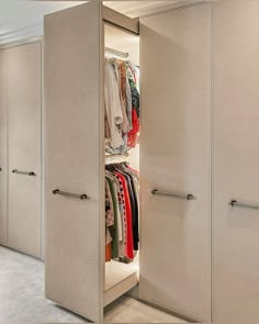 an open closet with clothes on hangers