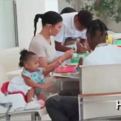 a group of people sitting around a table with plates and cups in front of them