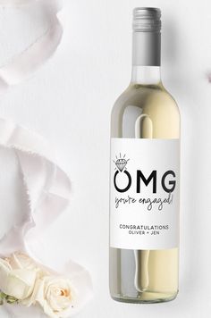 a bottle of omg wine next to a rose on a white background with the word omg written in black