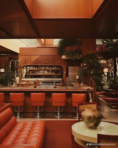 a living room filled with furniture and a bar