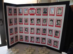 an open book with pictures and candles on the table in front of it, which is decorated with red and white photos