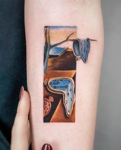 a woman's arm with a piece of art on the side of her body