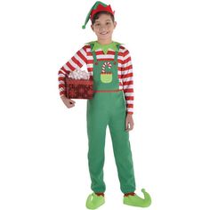 a young boy dressed in an elf costume holding a christmas basket and smiling at the camera