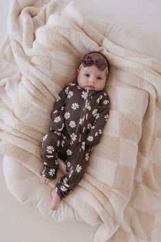 A baby is dressed in the Midnight Meadow bamboo zip pajamas from Forever French Baby, paired with a matching headband, and lies on a soft, beige checked blanket. Checked Blanket, French Baby, Bamboo Pajamas, Cozy Pajamas, Future Family, Soft Beige, The Midnight, Matching Headband, Christmas 2024