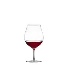 a wine glass filled with red wine on a white background