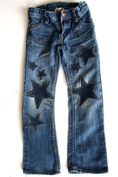 a pair of jeans with stars painted on them