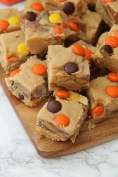 a wooden cutting board topped with candy bars