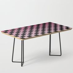 a pink and black checkered table with hairpin legs on an isolated white background