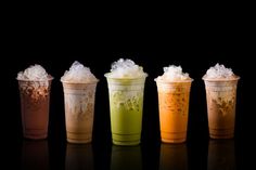 five different types of drinks in plastic cups